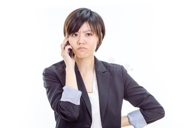 Chinese businesswoman in casual office clothes on cell phone looking annoyed. Chinese businesswoman in casual office clothes on cell phone looking annoyed