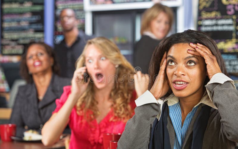 Annoyed lady listening to obnoxious women on phone. Annoyed lady listening to obnoxious women on phone