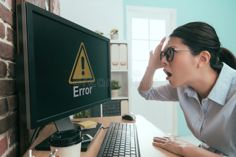 Annoyed company manager lady finding office working computer getting mistake problem showing error symbol feeling angry and confused. Annoyed company manager lady finding office working computer getting mistake problem showing error symbol feeling angry and confused.