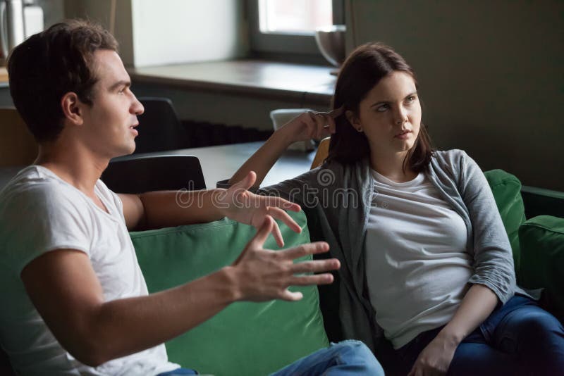 Annoyed girl tired of listening to boring boyfriend at home royalty free stock photos Annoyed girl tired of listening to boring boyfriend at home royalty free stock photos