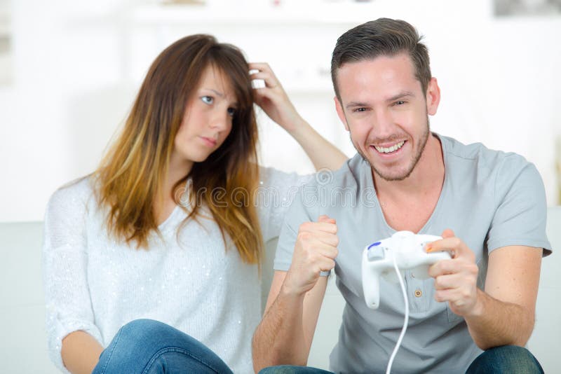 Annoyed Girlfriend Waiting for Boyfriend To Stop Playing Video-games Stock  Photo - Image of game, gamer: 100430632