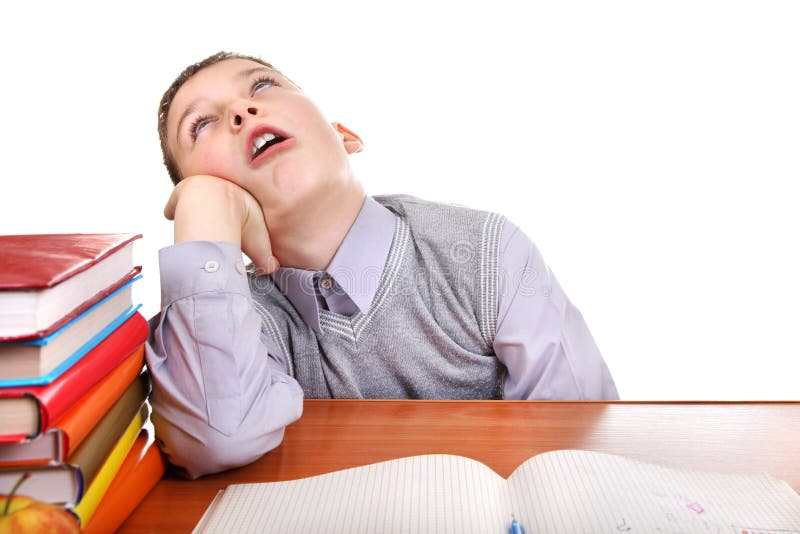 Annoyed Kid on the School Desk on the white background. Boring kid white stock images, royalty-free photos and pictures