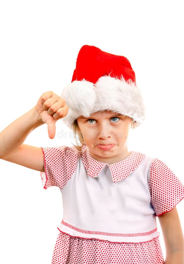 Annoyed Small Girl in Santa Hat make Thumb Down on the White Background