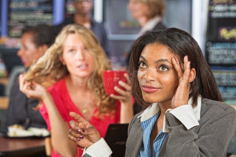 Annoyed Black women talking with emotional friend. Annoyed Black women talking with emotional friend