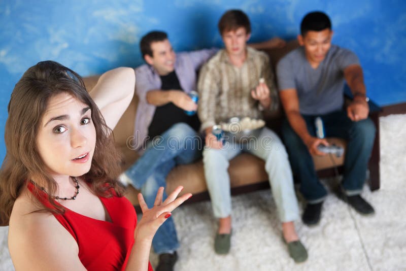 Annoyed young Caucasian women with three men playing video games. Annoyed young Caucasian women with three men playing video games