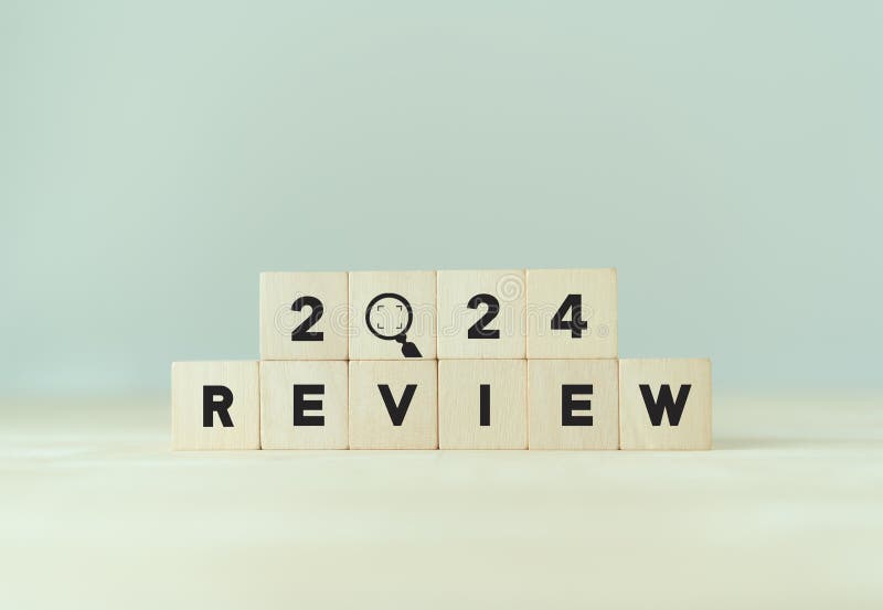2024 Review New Year Symbol. Businessman Turns a Wooden Cube and