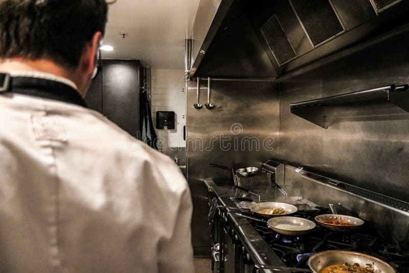 Anonymous chef standing on restaurant kitchen