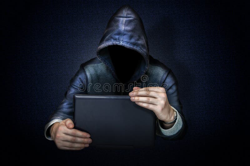 Anonymous hacker with laptop stock photography