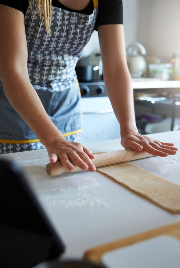 Anonymous person using a pin to make fresh pasta at home royalty free stock photos