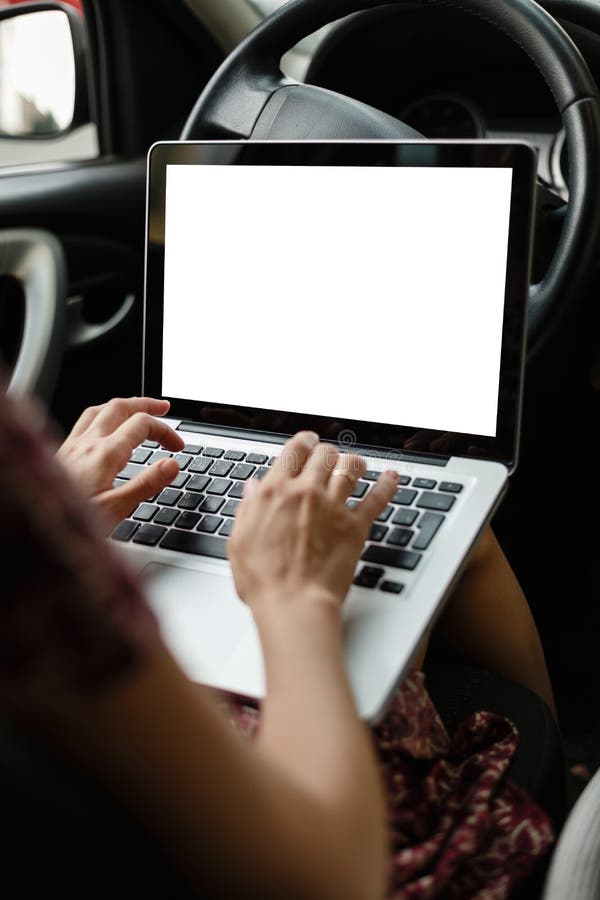 Anonymous woman browsing laptop in car royalty free stock images