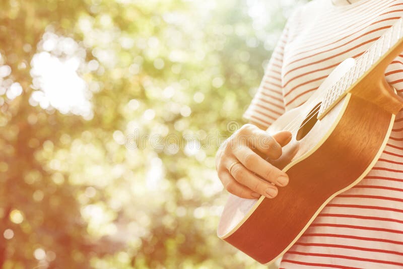 Anonymous woman playing ukulele royalty free stock photos