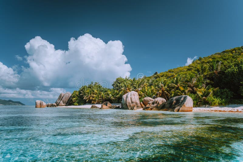 Anse Source d`Argent - Cloudscape over paradise beach with bizarre rocks and shallow lagoon water on La Digue island in Seychelles. Anse Source d`Argent - Cloudscape over paradise beach with bizarre rocks and shallow lagoon water on La Digue island in Seychelles.