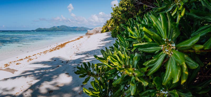 Anse Source d`Argent Paradise beach in the morning with view to Praslin Island on horizon, La Digue in Seychelles. Anse Source d`Argent Paradise beach in the morning with view to Praslin Island on horizon, La Digue in Seychelles.