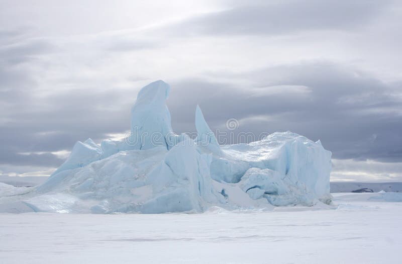 Iceberg frozen solid in the sea ice of Antarctica. Iceberg frozen solid in the sea ice of Antarctica