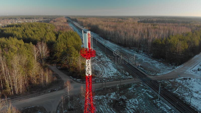 Antenna for 4G or 5G wireless mobile networks near railway tracks against a forest background