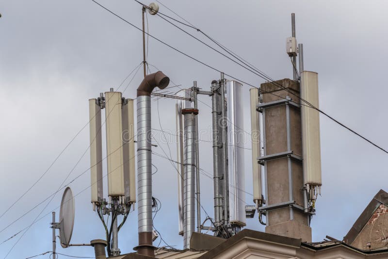Antennae of cellular and communication systems with the blue sky background on the roof of the building. stock image Antennae of cellular and communication systems with the blue sky background on the roof of the building. stock image