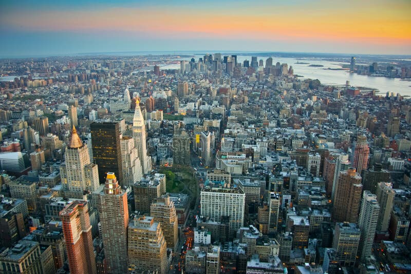 Aerial view over lower Manhattan, New York from Empire State building top at dusk. Aerial view over lower Manhattan, New York from Empire State building top at dusk