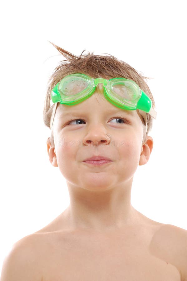 Smiling elementary age boy with wet hair and goggles over white. Smiling elementary age boy with wet hair and goggles over white