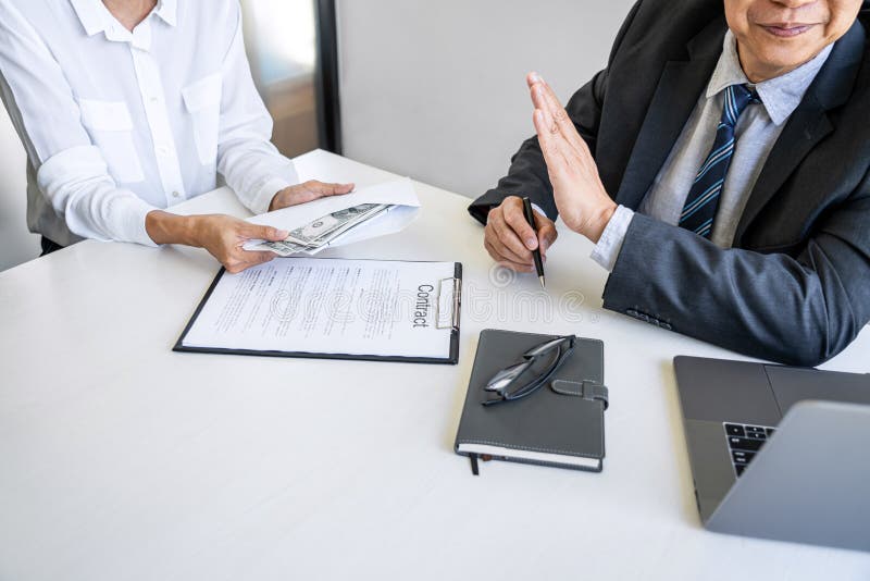 Anti Bribery and corruption concept, bribe in the form of dollar bills, consultant refuse receive money from business woman while stock photography Anti Bribery and corruption concept, bribe in the form of dollar bills, consultant refuse receive money from business woman while stock photography