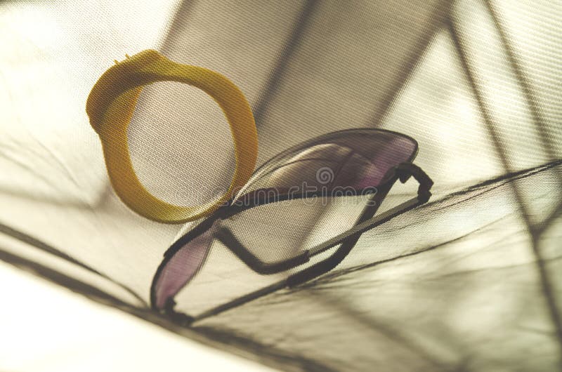Anti insect bracelet and sunglasses stock photography