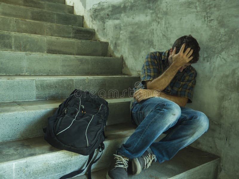 Campaign vs homophobia with young sad and depressed college student man sitting on staircase desperate victim of harassment royalty free stock images Campaign vs homophobia with young sad and depressed college student man sitting on staircase desperate victim of harassment royalty free stock images