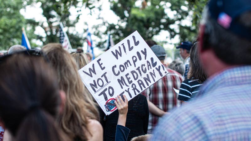 Anti-vaccine mandate protest sign held by child with american flag