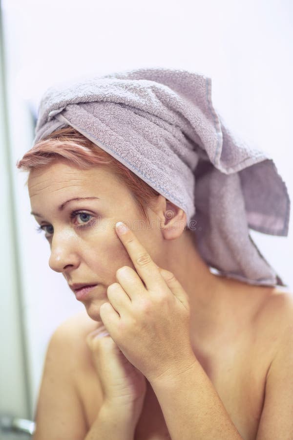 Anti-wrinkles care concept- woman is worried about the wrinkles on her face stock photography Anti-wrinkles care concept- woman is worried about the wrinkles on her face stock photography