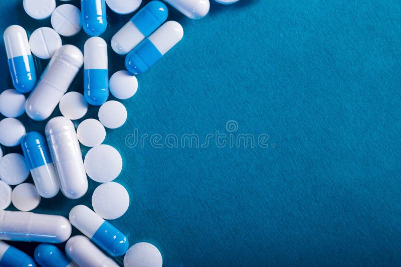 Antibiotic And Probiotics Pills On A Blue Background. Pharmaceutical