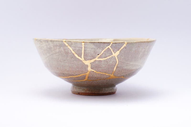 Kintsugi tea bowl cups. Gold cracks restoration on old Japanese pottery restored with the antique restoration technique.The unique beauty of imperfections. Kintsugi tea bowl cups. Gold cracks restoration on old Japanese pottery restored with the antique restoration technique.The unique beauty of imperfections.