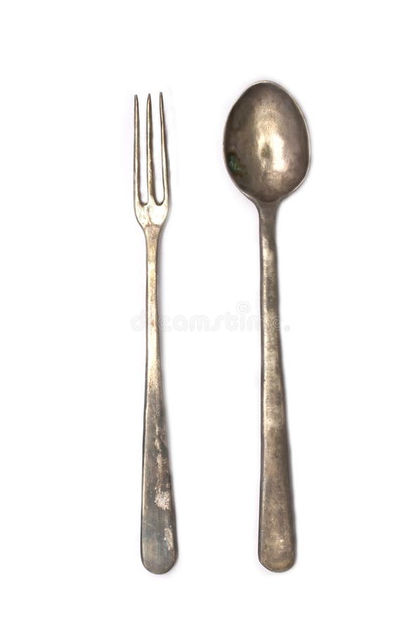 A set of antique silver cutlery-- a long-tined fork and a dainty spoon. A set of antique silver cutlery-- a long-tined fork and a dainty spoon.