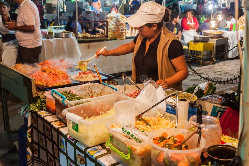 ANTIGUA, GUATEMALA - MARCH 26, 2016: Food stall at a market in Antigua Guatemala town, Guatemal stock photo ANTIGUA, GUATEMALA - MARCH 26, 2016: Food stall at a market in Antigua Guatemala town, Guatemal stock photo