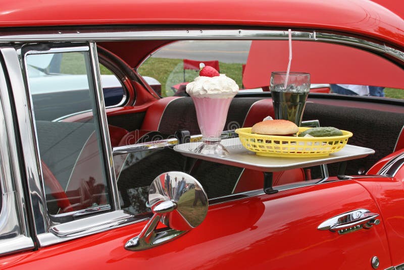 Tray of food on antique car brought by car hop. Tray of food on antique car brought by car hop