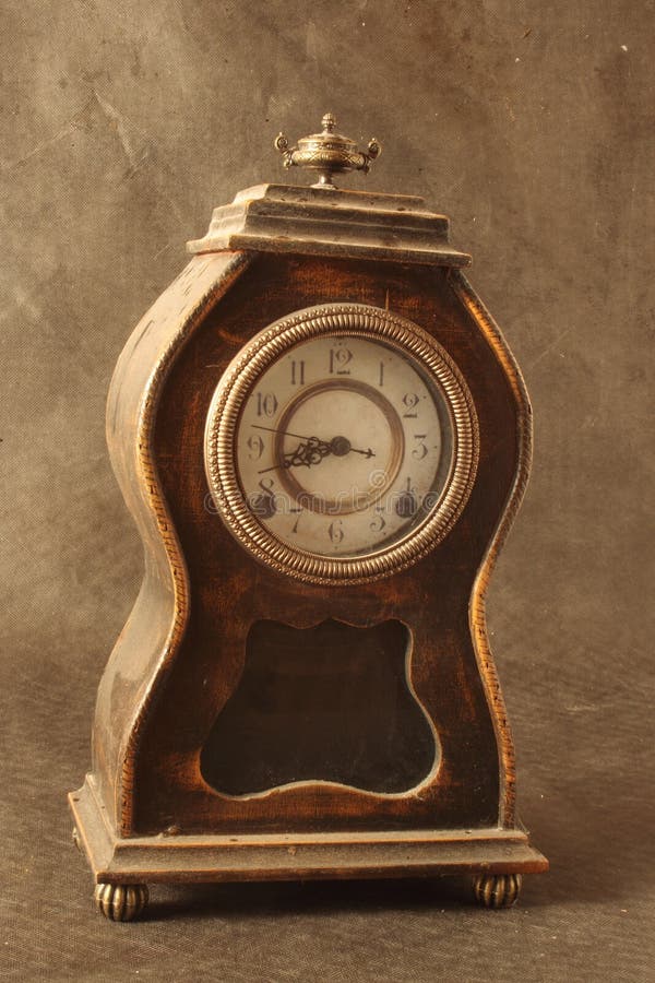 Old, brown, antique clock on rough, old looking background. Old, brown, antique clock on rough, old looking background