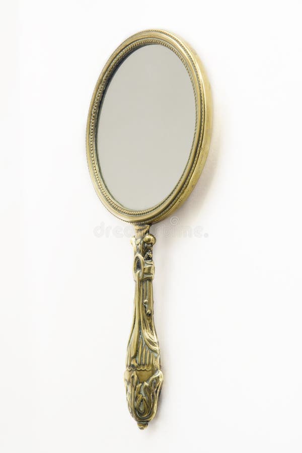 Ornate antique Art Deco brass hand-mirror. Isolated on white. Ornate antique Art Deco brass hand-mirror. Isolated on white