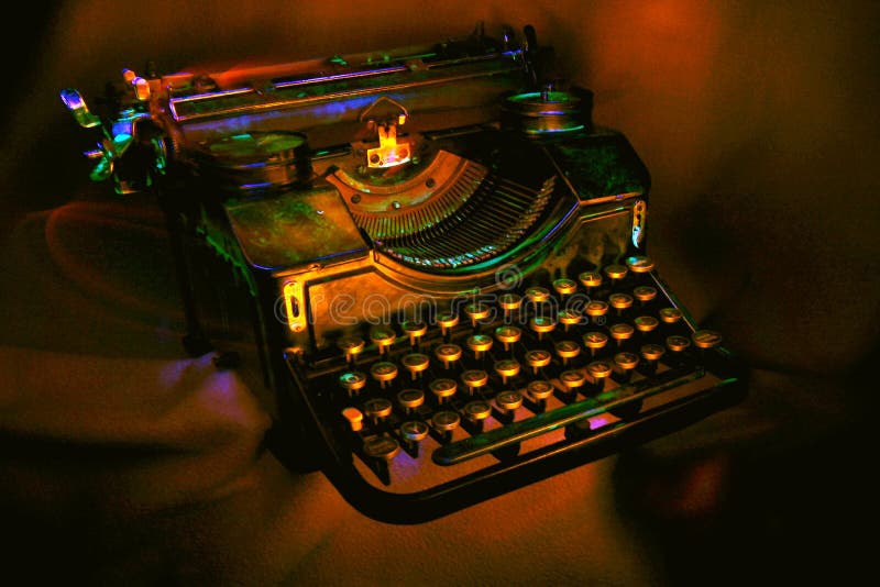 Antique black typewriter painted with UV light. Various objects on a dark background. Artistic blur. Antique black typewriter painted with UV light. Various objects on a dark background. Artistic blur.