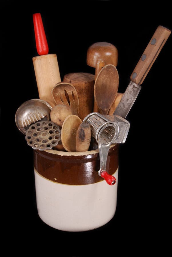 A collection of late 19th to mid 20th century kitchen utensils, including ice scapers, potato ricer, wooden spoons, rolling pin, knife, displayed in an antique ceramic crock. A collection of late 19th to mid 20th century kitchen utensils, including ice scapers, potato ricer, wooden spoons, rolling pin, knife, displayed in an antique ceramic crock