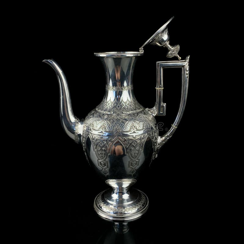 Antique arabic metal teapot with national patterns. metal israeli teapot on black isolated background. Antique arabic metal teapot with national patterns. metal israeli teapot on black isolated background