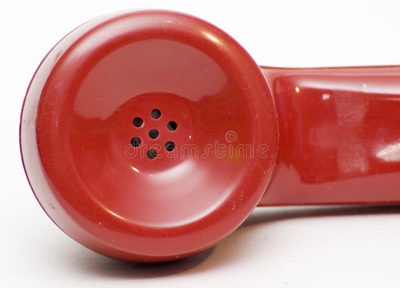 The earpiece from an antique red rotary phone. The earpiece from an antique red rotary phone