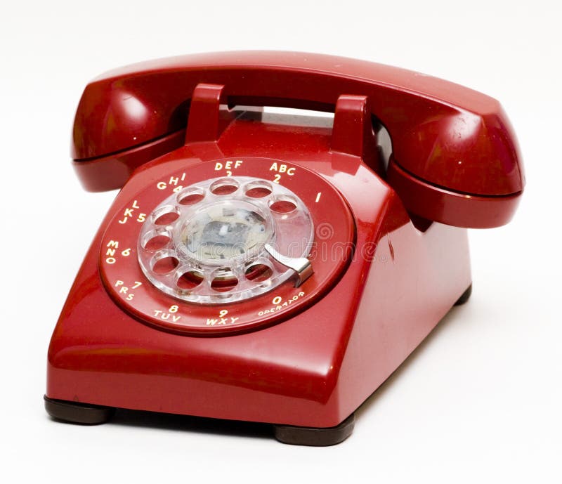 An red rotary phone from the 1960's or 1970's. An red rotary phone from the 1960's or 1970's.