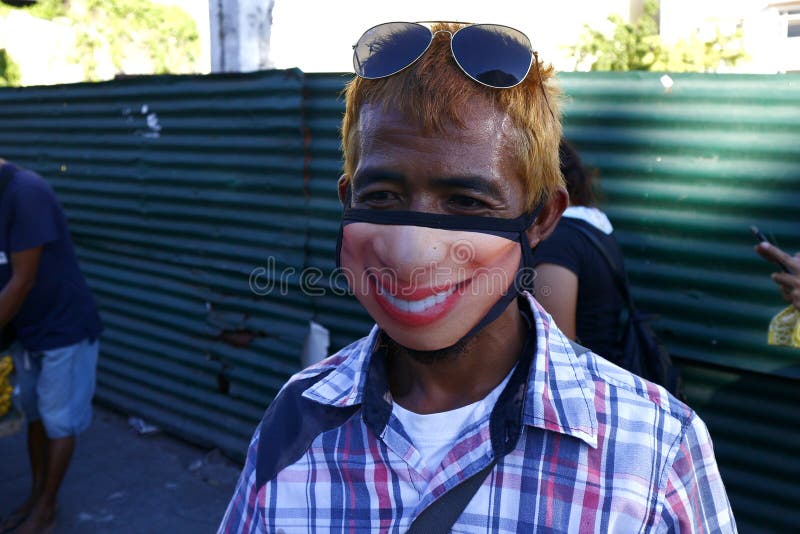Filipino Man Use a Face Mask with a Funny Face Printed on it during the  Covid 19 Virus Outbreak Editorial Stock Image - Image of fabric, mouth:  186305539