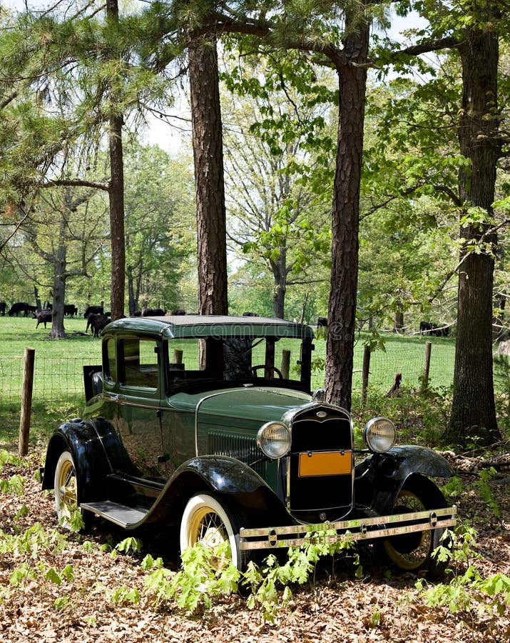 Antique car in rural scene.