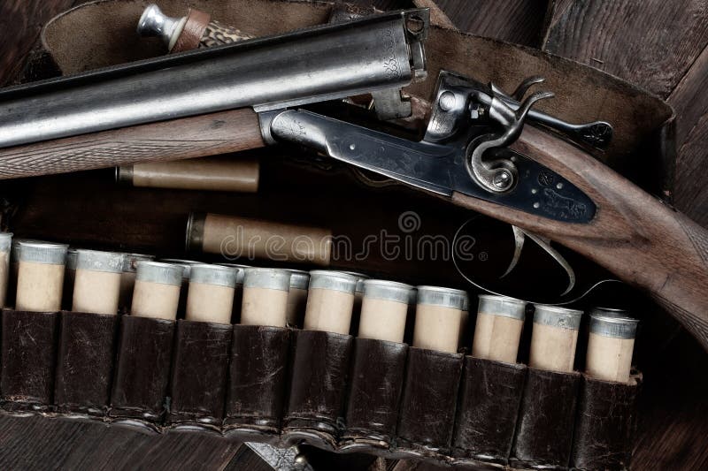 Antique 12 gauge break action smooth bored double barreled shotgun with paper cases stock photos