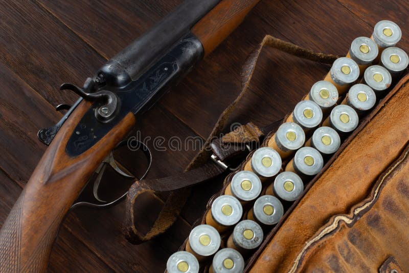 Antique 12 gauge break action smooth bored double barreled side shotgun with cases stock photos