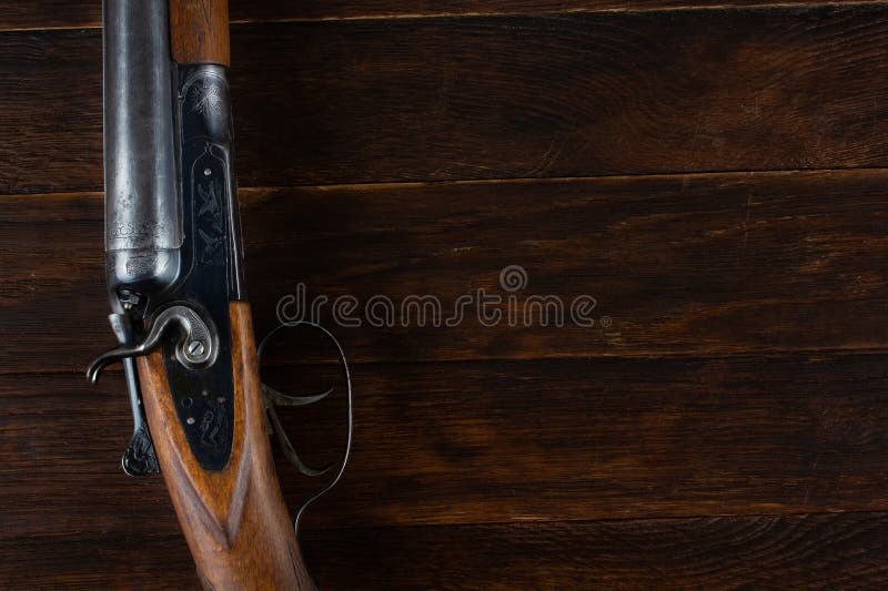 Antique 12-gauge break-action smooth-bored shotgun with paper cases royalty free stock photo