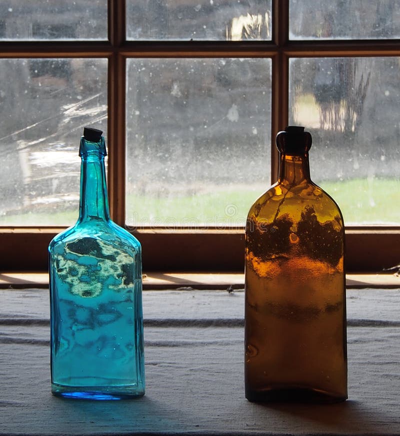 Antique Glass Bottles in Window