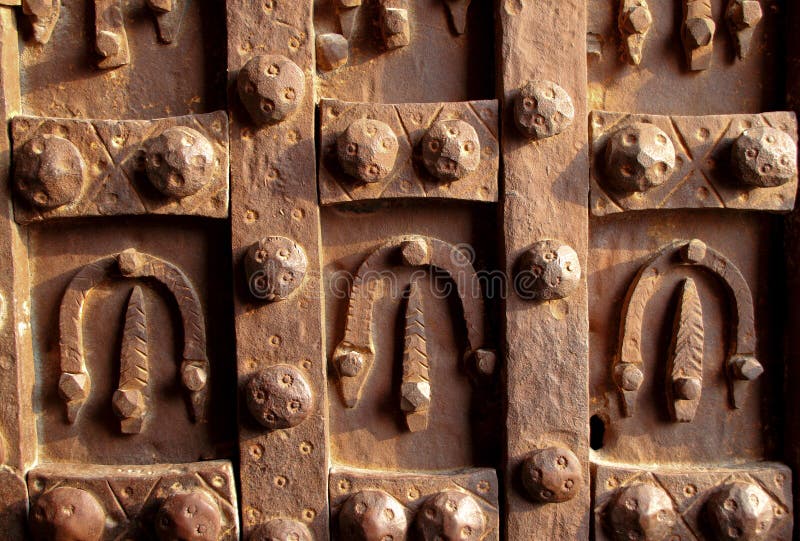 Antique iron door decorated with horseshoes stock photo