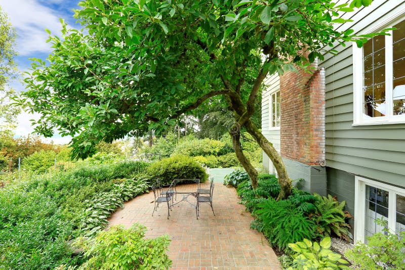 Antique iron table set on patio area with tile floor stock photo