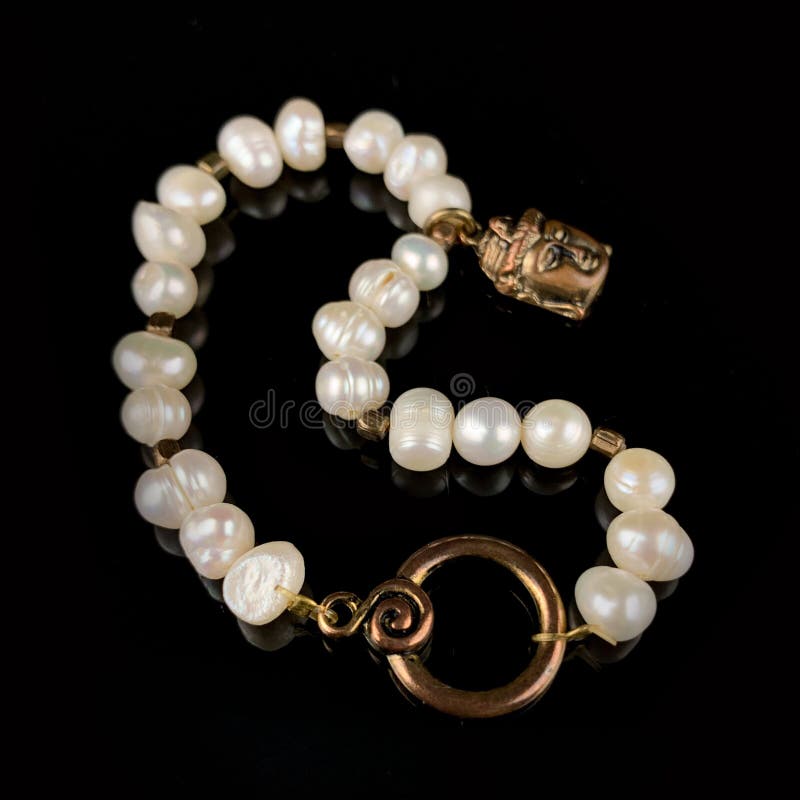 Antique Pearl Bracelet with Buddha Head. Antique Bracelet on Black ...