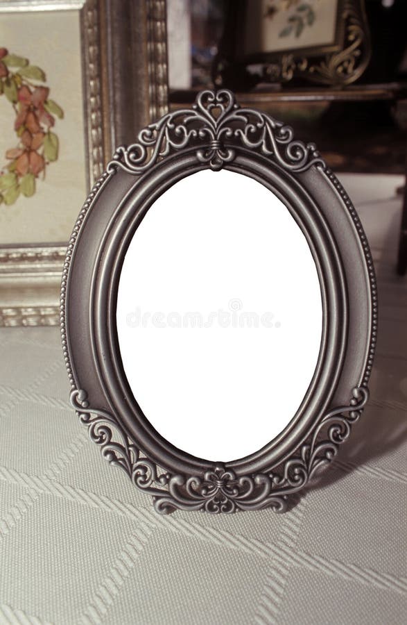 An antique tin/pewter picture frame with blank oval center for future image placement. An antique tin/pewter picture frame with blank oval center for future image placement