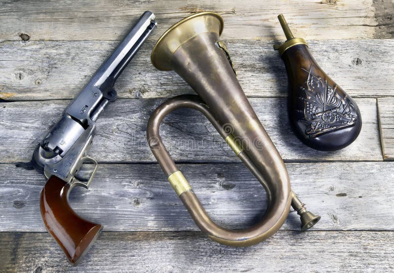 Antique cowboy pistol, brass bugel and  gunpowder flask. These would be items a civil war soildier would carry. Antique cowboy pistol, brass bugel and  gunpowder flask. These would be items a civil war soildier would carry